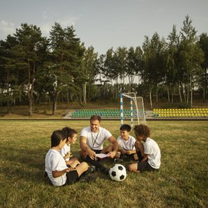 kids-playing-football-supervised-by-football-trainer