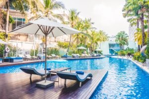 Umbrella pool and chair around beautiful luxury swimming pool in hotel resort - Vintage Light film Filter